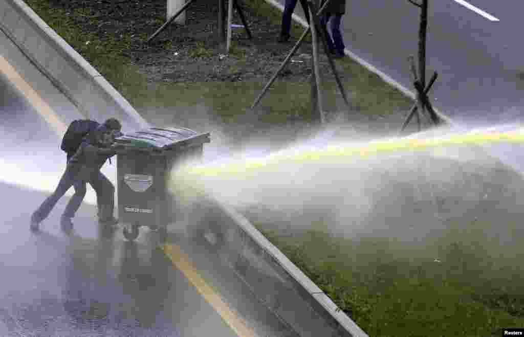 Riot police use a water cannon to disperse anti-government protesters near the Middle East Technical University (ODTU) in Ankara, Turkey. A 15-year-old Turkish boy, who suffered a head injury during anti-government protests in Istanbul last June, died after spending months in a coma, triggering renewed clashes between police and his family&#39;s supporters.