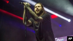 FILE - Post Malone performs at the Voodoo Music Experience in City Park in New Orleans, Oct. 29, 2017.