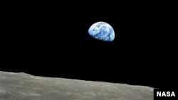 FILE - The distant blue Earth is seen above the Moon's limb, in this handout picture taken by the Apollo 8 crew forty-five years ago, on December 24, 1968, courtesy of NASA. 