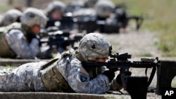 FILE - Female soldiers from 1st Brigade Combat Team, 101st Airborne Division train on a firing range while testing new body armor in Fort Campbell, Kentucky, Sept. 18, 2012.