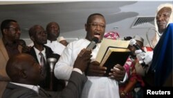 Opposition candidate and former military junta leader Julius Maada Bio takes his oath as Sierra Leone's new president, in Freetown, April 4, 2018. 