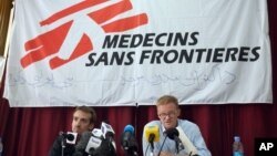 FILE - The general director of medical charity, Medecins Sans Frontieres (MSF), Christopher Stokes, right, talks as MSF's Guilhem Molinie, left, listens, during a press conference, in Kabul, Afghanistan, Oct. 8, 2015.