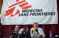 The general director of medical charity, Medecins Sans Frontieres (MSF), Christopher Stokes, right, talks as MSF's Country Representative for Afghanistan, Guilhem Molinie, left, listens, during a press conference at their office, in Kabul.