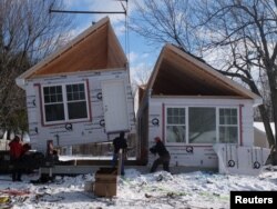 Workers prepare to put together a single-family modular home in Depew, New York, in Feb. 2017.