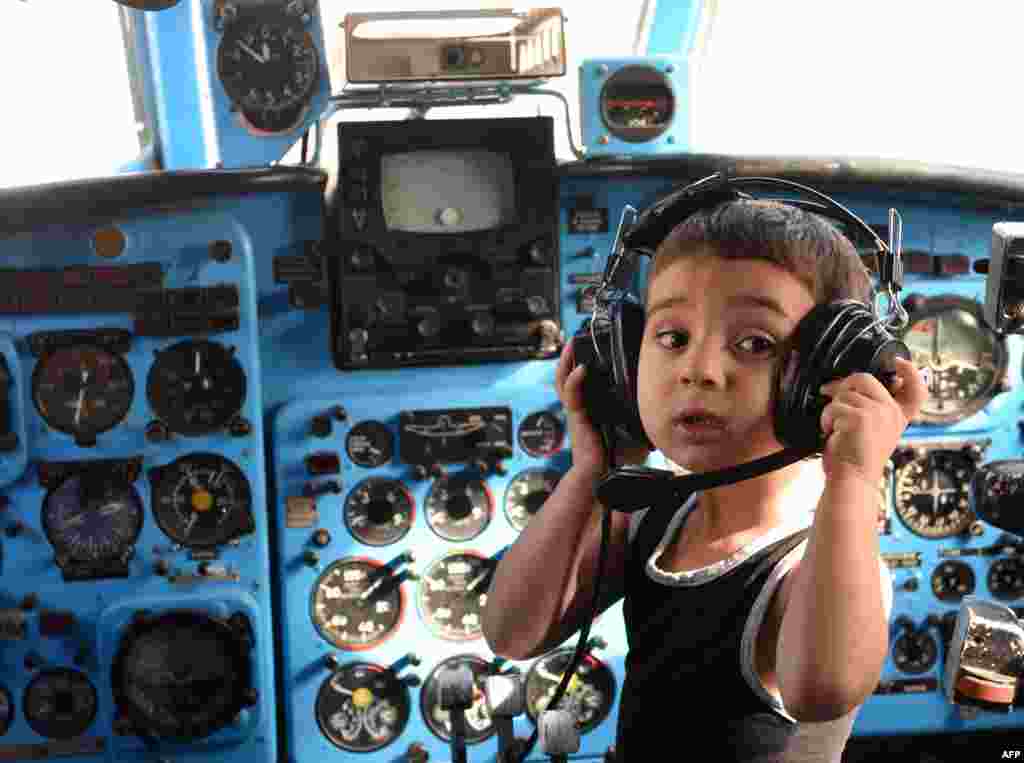 A boy plays inside a Soviet-era Yakovlev Yak-40 plane turned into their kindergarten in the Georgian city of Rustavi, some 25 km southeast of the capital Tbilisi. Local head teacher Gari Chapidze bought the old but fully functional Yak-40 from Georgian Airways and refurbished its interior with educational equipment, games and toys but left the cockpit instruments intact so they could be used as play tools.