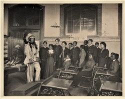 Louis Firetail, a Western Dakota student from the Crow Creek Reservation in S. Dakota, poses for a history class at Hampton Institute, Va., ca. 1899.