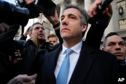 FILE - Michael Cohen walks out of federal court in New York, Nov. 29, 2018.
