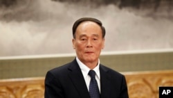 FILE - Wang Qishan attends a press event at Beijing's Great Hall of the People.