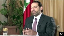 Lebanon’s Prime Minister Saad Hariri gives a live TV interview in Riyadh, Saudi Arabia, Sunday Nov. 12, 2017, saying he will return to his country “within days”.