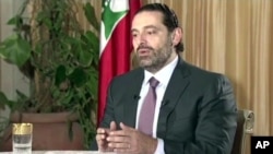 FILE - Lebanon’s Prime Minister Saad Hariri gives a live TV interview in Riyadh, Saudi Arabia, Sunday Nov. 12, 2017, saying he will return to his country “within days”.