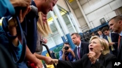 Democratic presidential candidate Hillary Clinton reacts while greeting supporters after giving a speech on the economy at Futuramic Tool & Engineering, in Warren, Mich., Aug. 11, 2016. 