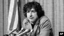 FILE - political activist Tom Hayden, husband of actress Jane Fonda, speaks to the press in Los Angeles, California, Dec. 6, 1973. Hayden and Fonda made a trip to North Vietnam in protest of the U.S. involvement in the war against Hanoi.