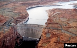 FILE - The Glen Canyon dam holds back the Colorado River creating Lake Powell near Page, Arizona, May 26, 2015.