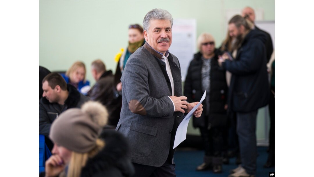 Communist party candidate Pavel Grudinin prepares to cast his ballot in the presidential election at the Lenin state farm outside Moscow, Sunday, March 18, 2018.