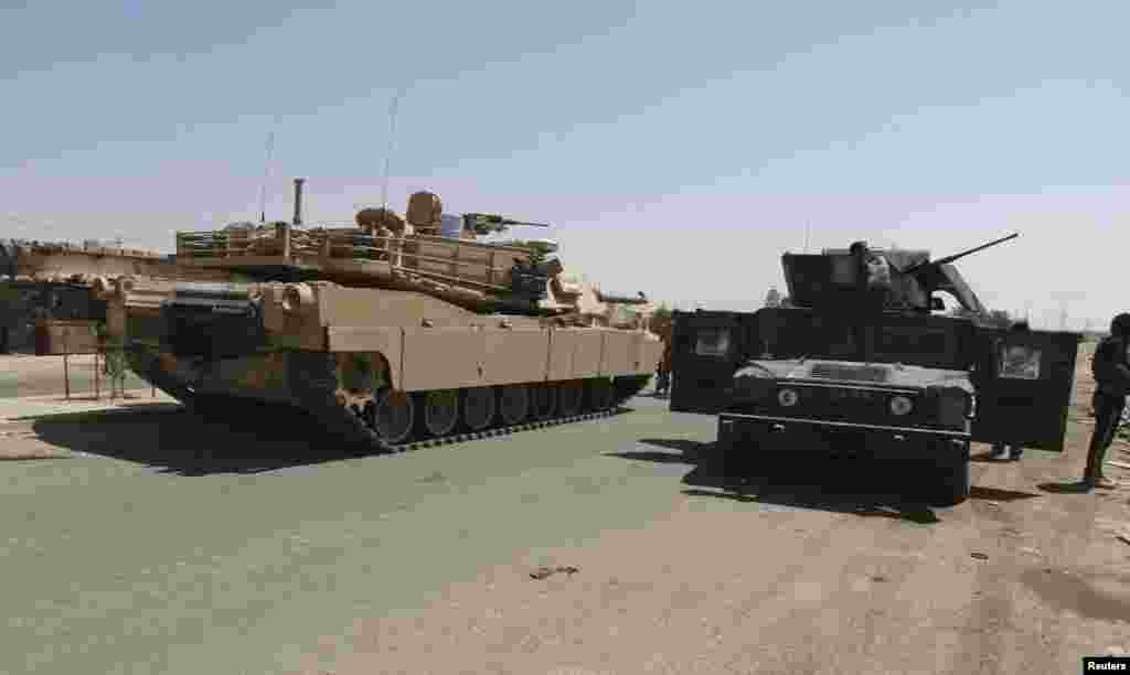 A convoy of Iraqi security forces is seen during a patrol for Islamic State militants on the outskirts of Ramadi, Sept. 14, 2014.