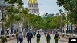 Police officers walk along El Paseo del Prado street in Havana, on November 15, 2021.