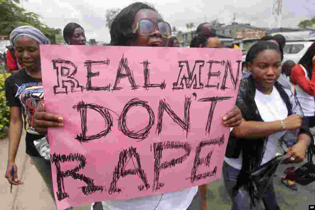 A woman carries a placard as she shouts a slogan during the "walk against rape'" procession organised by "Project Alert", a Lagos-based NGO focusing on women's issues, in Nigeria's commercial capital Lagos.