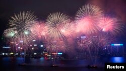 Fireworks explode over Victoria Harbour to celebrate the Chinese Lunar New Year in Hong Kong February 11, 2013. 
