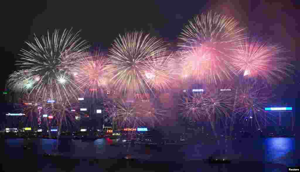 Los fuegos artificiales estallan sobre el puerto Victoria para celebrar el inicio del nuevo a&ntilde;o lunar chino en Hong Kong. 