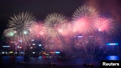 Fireworks explode over Victoria Harbour to celebrate the Chinese Lunar New Year in Hong Kong February 11, 2013. 
