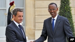 France's President Nicolas Sarkozy (L) welcomes his Rwandan counterpart Paul Kagame as he arrives at the Elysee palace in Paris, September 12, 2011.