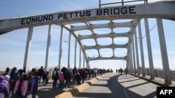 Schoolchildren walk across the Edmund Pettus Bridge as they visit historic sites from the Selma to Montgomery civil rights march, March 6, 2015, in Selma, Alabama.