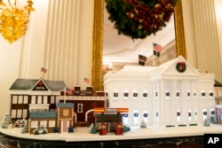 Gingerbread houses sit in the East Room of the White House during a press preview of the White House holiday decorations, Nov. 29, 2021.