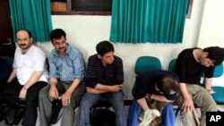 Suspected Afghan illegal immigrants, who were in transit in the province of North Sumatra, possibly bound for Australia, rest at a police station in Medan, Indonesia, after being brought in for questioning (File Photo)