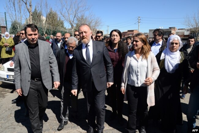 FILE - Co-leader of the pro-Kurdish Peoples' Democratic Party (HDP), Sezai Temelli, center, attends Kurdish activist Zulkuf Gezen's funeral in the Turkish city of Diyarbakir, March 18, 2019.