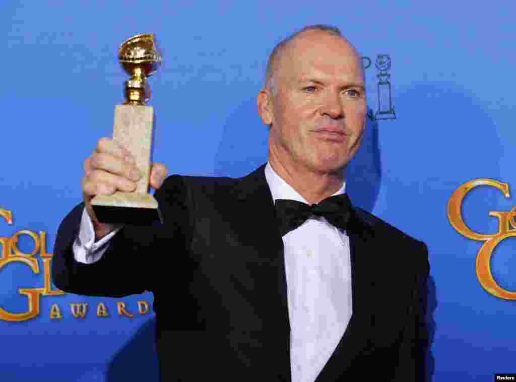 Michael Keaton poses backstage with his award for Best Actor in a Motion Picture, Musical or Comedy for his role in "Birdman" at the 72nd Golden Globe Awards in Beverly Hills, California, Jan. 11, 2015.