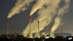 FILE - Smoke streams from the chimneys of the E.ON coal-fired power station in Gelsenkirchen, Germany, Nov. 24, 2014.
