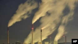 FILE - Smoke streams from the chimneys of a coal-fired power station in Gelsenkirchen, Germany, Nov. 24, 2014.