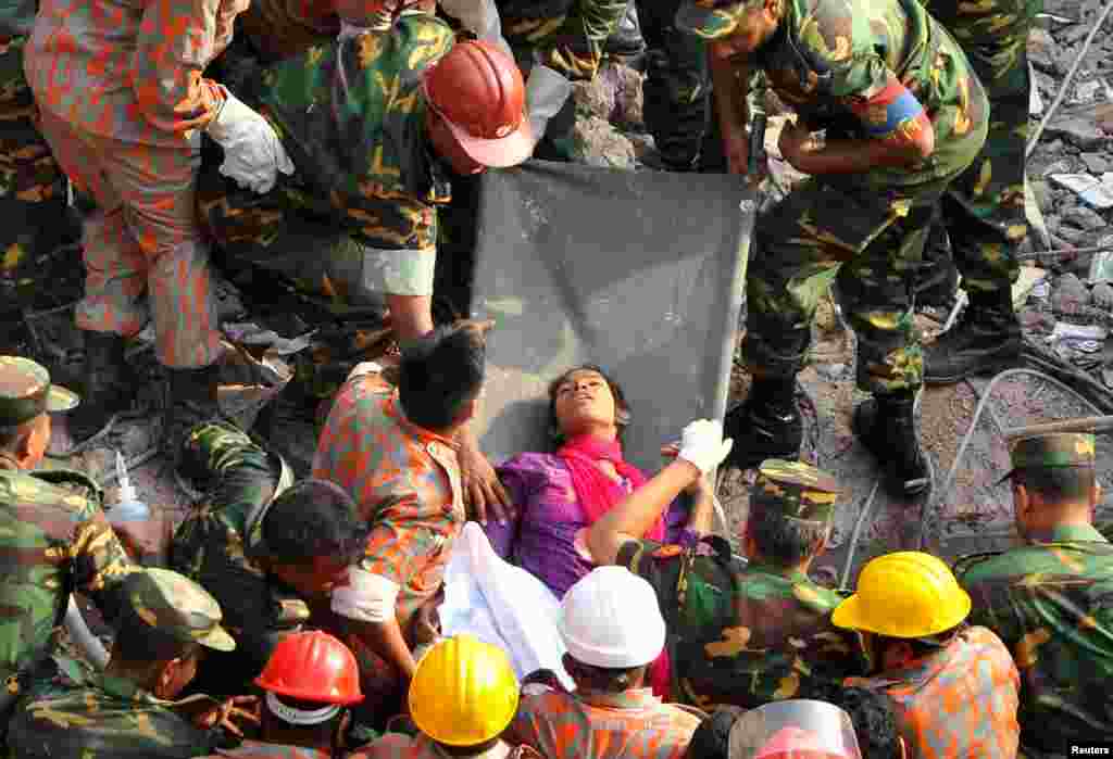 Rescue workers rescue a woman, identified by Bangladeshi media only as Reshma, from the rubble of the Rana Plaza building 17 days after the building collapsed in Savar, Bandladesh. The disaster has killed more than 1,000 people.