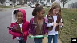 Troop 1822 Brownie Scouts Aliya Gill, left, Lindsey Russ, center, and Natalie Rouse, canvass a Raleigh, North Carolina neighborhood selling Girl Scout cookies on Saturday, Jan. 24, 2009 (file photo).