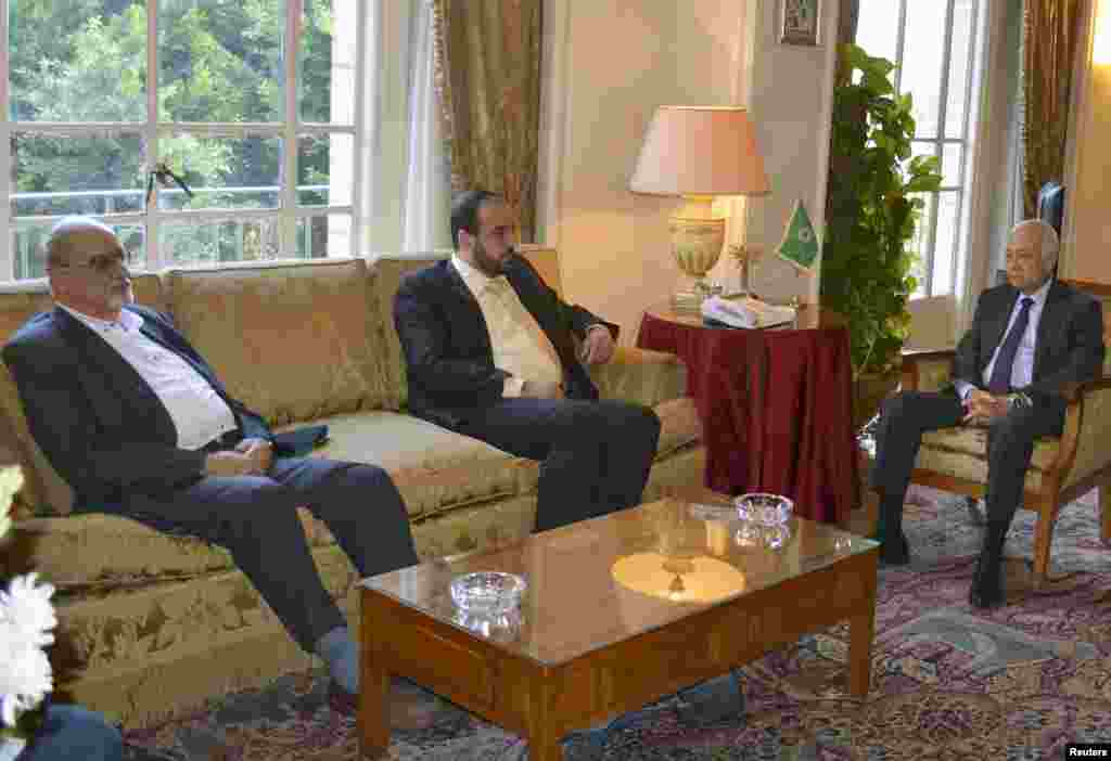Secretary General of the Arab League Chief Nabil al-Araby, right, meets with Syrian Coalition Secretary General Nasr al-Hariri, center, and Syrian opposition member Haitham al-Maleh at the Arab League's headquarters in Cairo, Sept. 6, 2014.