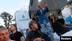 Turkish President Tayyip Erdogan makes a speech protected by bodyguards in Istanbul, Turkey, July 16, 2016. 