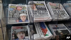 Newspapers fronted with photos of British Prime Minister Theresa May and others are displayed at a shop in Westminster in London, June 10, 2017.