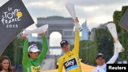 FILE - Chris Froome, center, celebrates his overall victory on the podium with Peter Sagan of Slovakia, left, holder of the best sprinter's green jersey, and Nairo Quintana of Colombia, holder of the best young rider's white jersey, after the final stage of the Tour de France, July 26, 2015. 