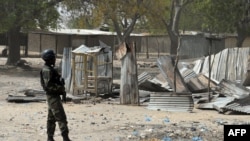FILE - A picture taken on February 17, 2015 shows a Cameroonian soldier walking in the Cameroonian town of Fotokol, on the border with Nigeria, after clashes occurred on Feb. 4 between Cameroonian troops and Nigeria-based Boko Haram insurgents. 