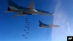 This photo provided by the Russian Defense Ministry Press Service purportedly shows Russian air force Tu-22M3 bombers striking Islamic State group targets in Syria, Jan. 23, 2017.