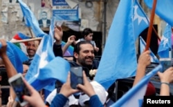 Lebanese prime minister and candidate in the parliamentary election Saad Hariri greets supporters in Beirut, Lebanon, May 4, 2018.