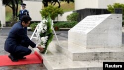 Japan's Prime Minister Shinzo Abe presents a wreath at the National Memorial Cemetery of the Pacific at Punchbowl in Honolulu, Hawaii, Dec. 26, 2016.