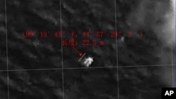 This image provided by China's State Administration of Science, Technology and Industry for National Defense shows a floating object seen at sea next to the descriptor which was added by the source. 