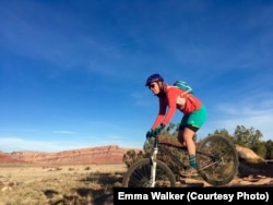 Emma Walker biking in the Moab Desert, Utah. She is wearing wool clothes while biking in March, 2017. (Credit Emma Walker)