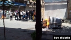 Anti-government protesters angered by Iran’s worsening economy set fire to garbage cans in Tehran’s Laleh Zar district, June 26, 2018.