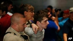 Police remove Michael Sandford as Republican presidential candidate Donald Trump speaks at the Treasure Island hotel and casino in Las Vegas, June 18, 2016.