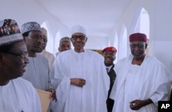 FILE - In this photo released by the Nigeria State House, Nigeria's President Muhammadu Buhari, center, walks with government officials after Friday prayers at the presidential palace in Abuja, Nigeria, May. 5, 2017.