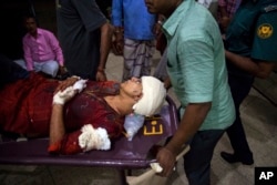 FILE - Rafida Ahmed, wife of Avijit Roy, is being rushed to hospital on a stretcher after she was seriously injured by unidentified attackers, in Dhaka, Feb. 25, 2015.