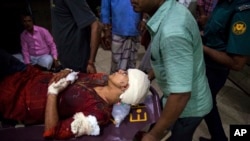 afida Ahmed, wife of a prominent Bangladeshi-American blogger, Avijit Raoy is being rushed to hospital on a stretcher after she was seriously injured by unidentified attackers, in Dhaka, Bangladesh, Feb. 25, 2015.