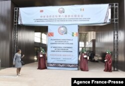 FILE - Senegalese delegates enter the conference hall during the China-Africa Cooperation (FOCAC) meeting at the Diamniadio in Dakar, Senegal, Nov. 29, 2021.